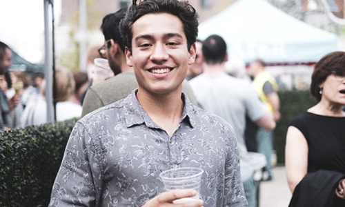 person at a party holding a drink and smiling