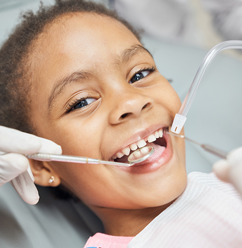 Young girl smiling during her dental checkup