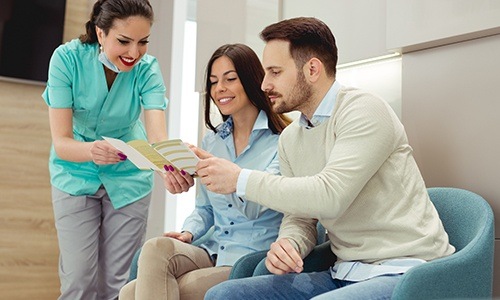 Team member showing patients forms