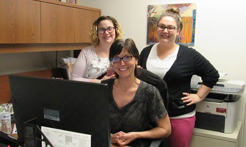 Team members behind reception desk