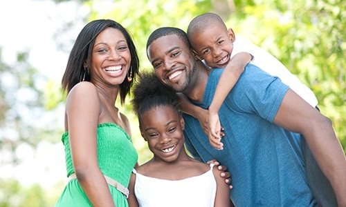 Parents and kids smiling outdoors