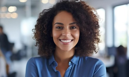 Closeup of woman in blue shirt smiling at office