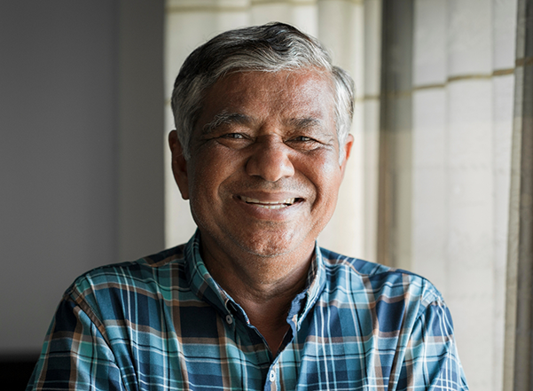 Smiling older man in a blue plaid shirt