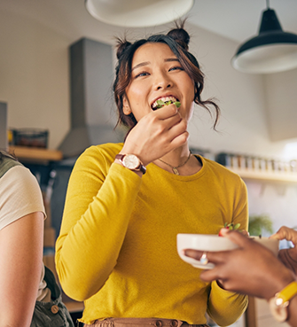 Young woman eating salad
