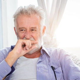 Senior man covering his mouth with his hand