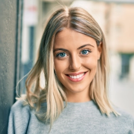 Young blonde woman in a gray shirt