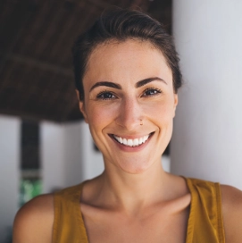 Woman in a dark yellow sleeveless blouse