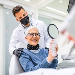 Patient checking smile with dentist in Worcester