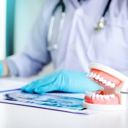 Dentist in Worcester with X-ray and model of teeth