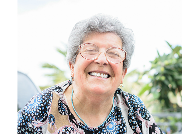 Senior woman in a colorful blouse grinning