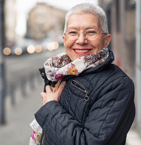 Older woman in a scarf and puffer jacket