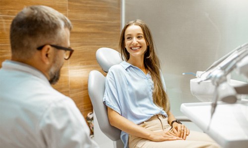 Female patient smiling at dentist at dental appointment