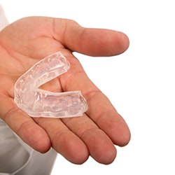 dentist holding mouthguard in hand 