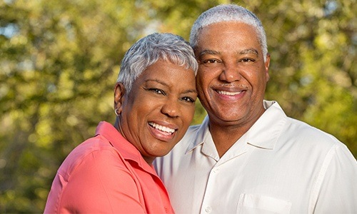 Smiling older man and woman outdoors