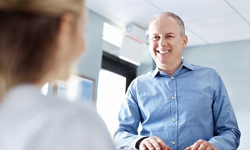 Smiling man at reception desk