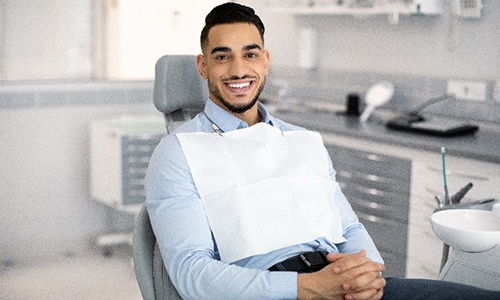 Man smiling while sitting in dentist's treatment chair