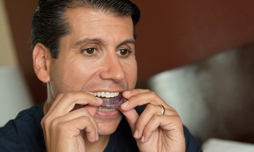 Man placing oral appliance