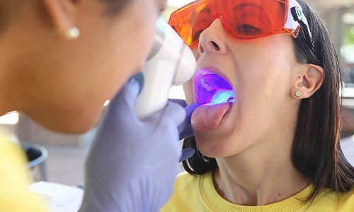 Woman receiving oral cancer screening