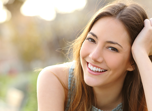 Young brunette woman smiling in the sun