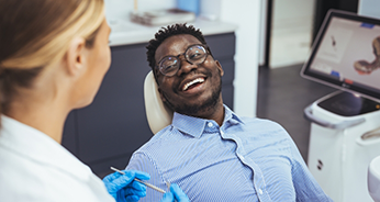 Man laughing with his dentist