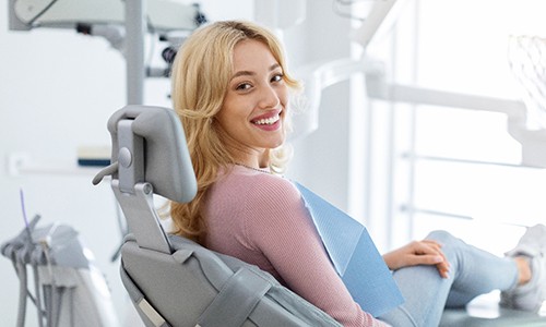 Happy dental patient looking over her shoulder