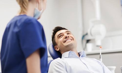 Man smiling while talking to Worcester cosmetic dentist