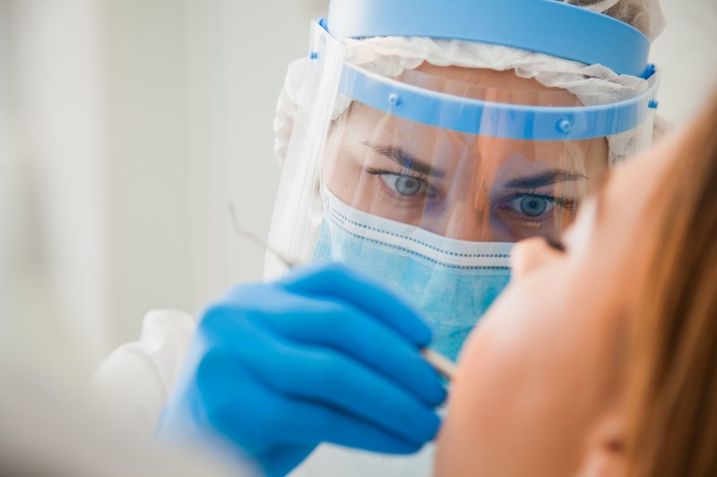 A dentist in Worcester wearing a face shield.