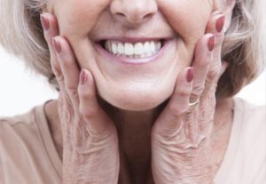 close up of elderly woman smiling with dentures in Worcester 