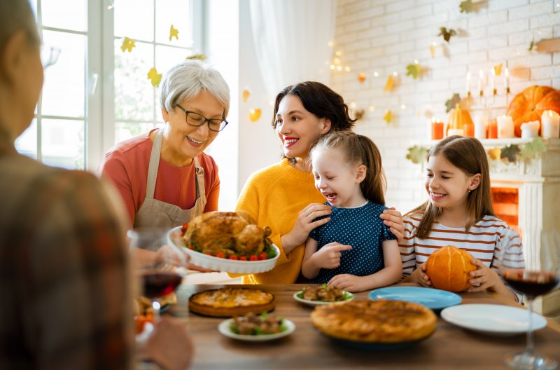 Grandma serving Thanksgiving meal to family