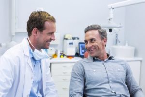 Man chatting with his dentist during dental checkup