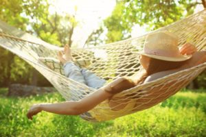 Woman relaxing in hammock after wisdom teeth removal 