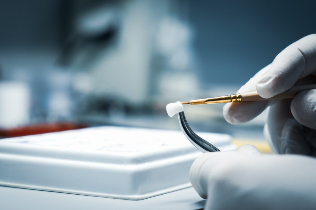 Closeup of lab artisan creating dental crown