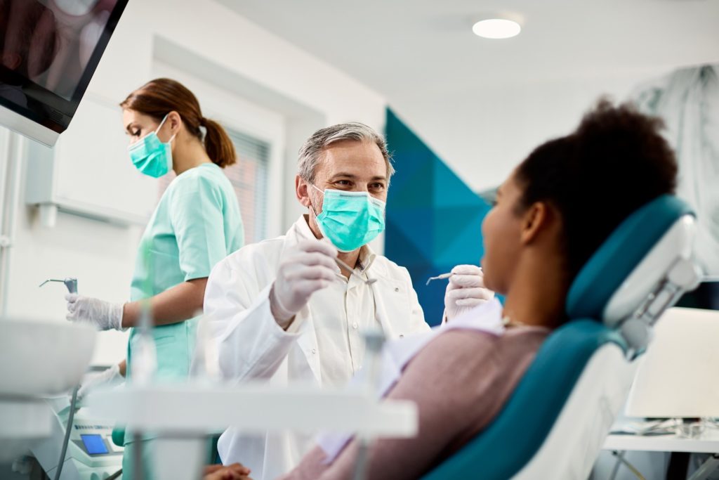 Patient and dentist smiling during dental checkup