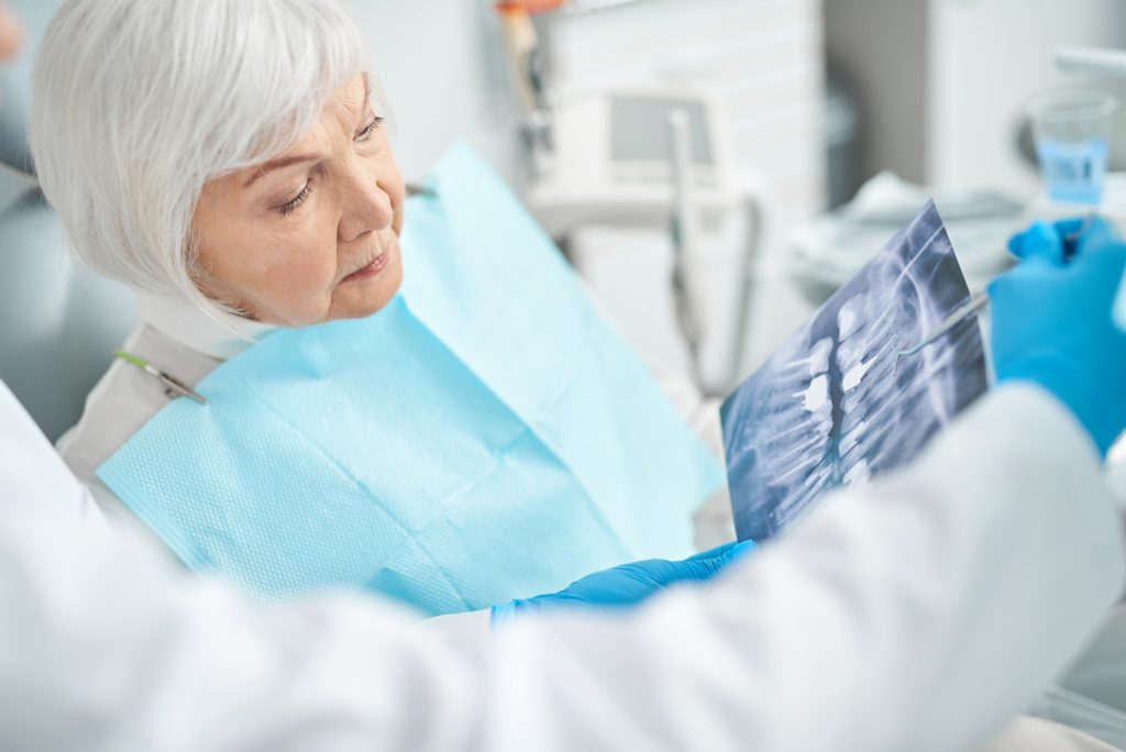 Dentist explaining X-ray to patient