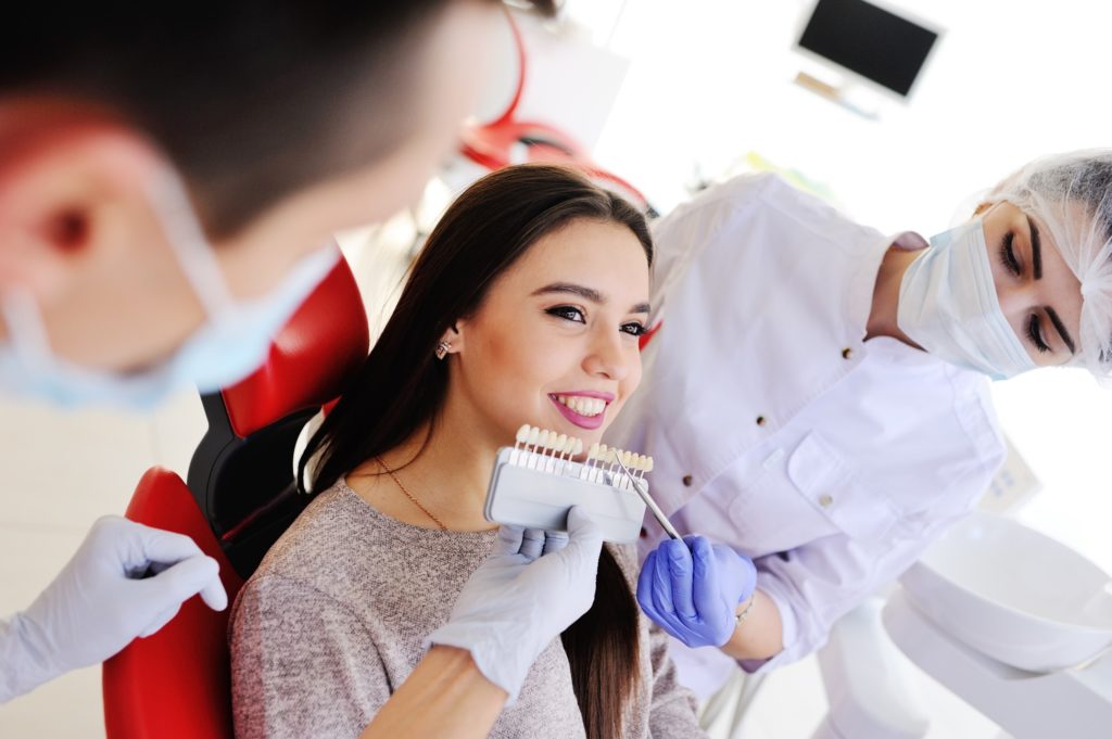 Woman smiling during shade selection process for veneers