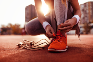 a person tying their running shoes