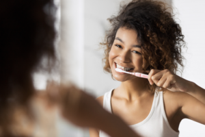 a young woman brushing her teeth