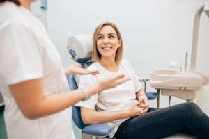 a patient smiling while visiting her dentist