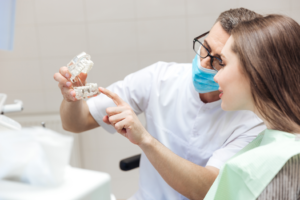 a dentist and patient speaking about dental implants