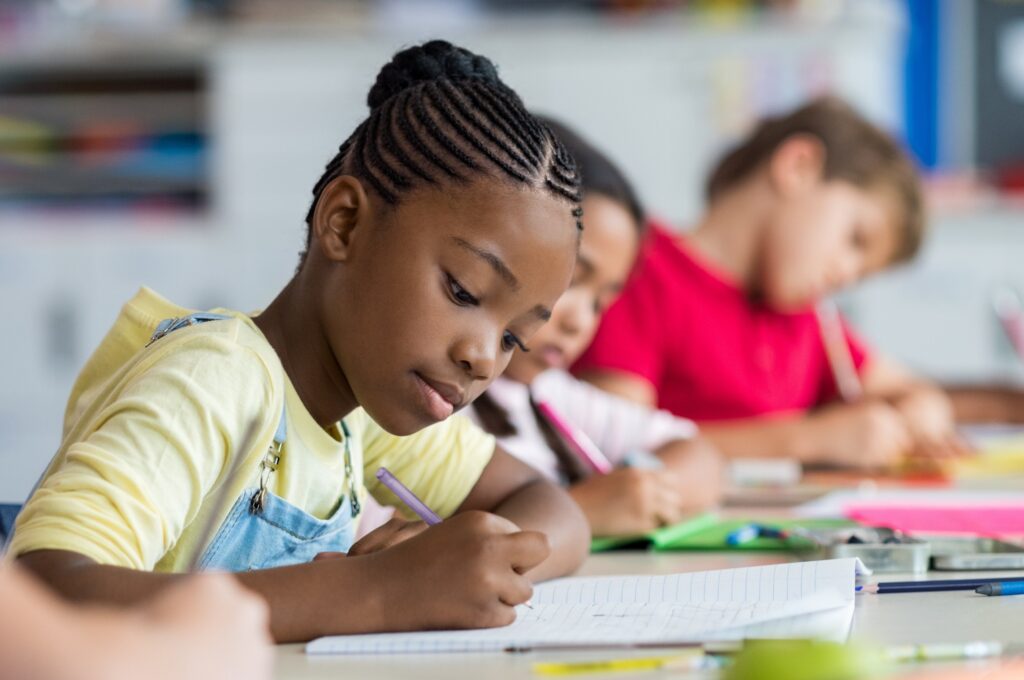 Children working on assignment in classroom