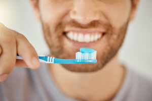 a person brushing their teeth at home